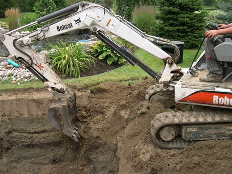 digging a pond with mini digger|creating a small backyard pond.